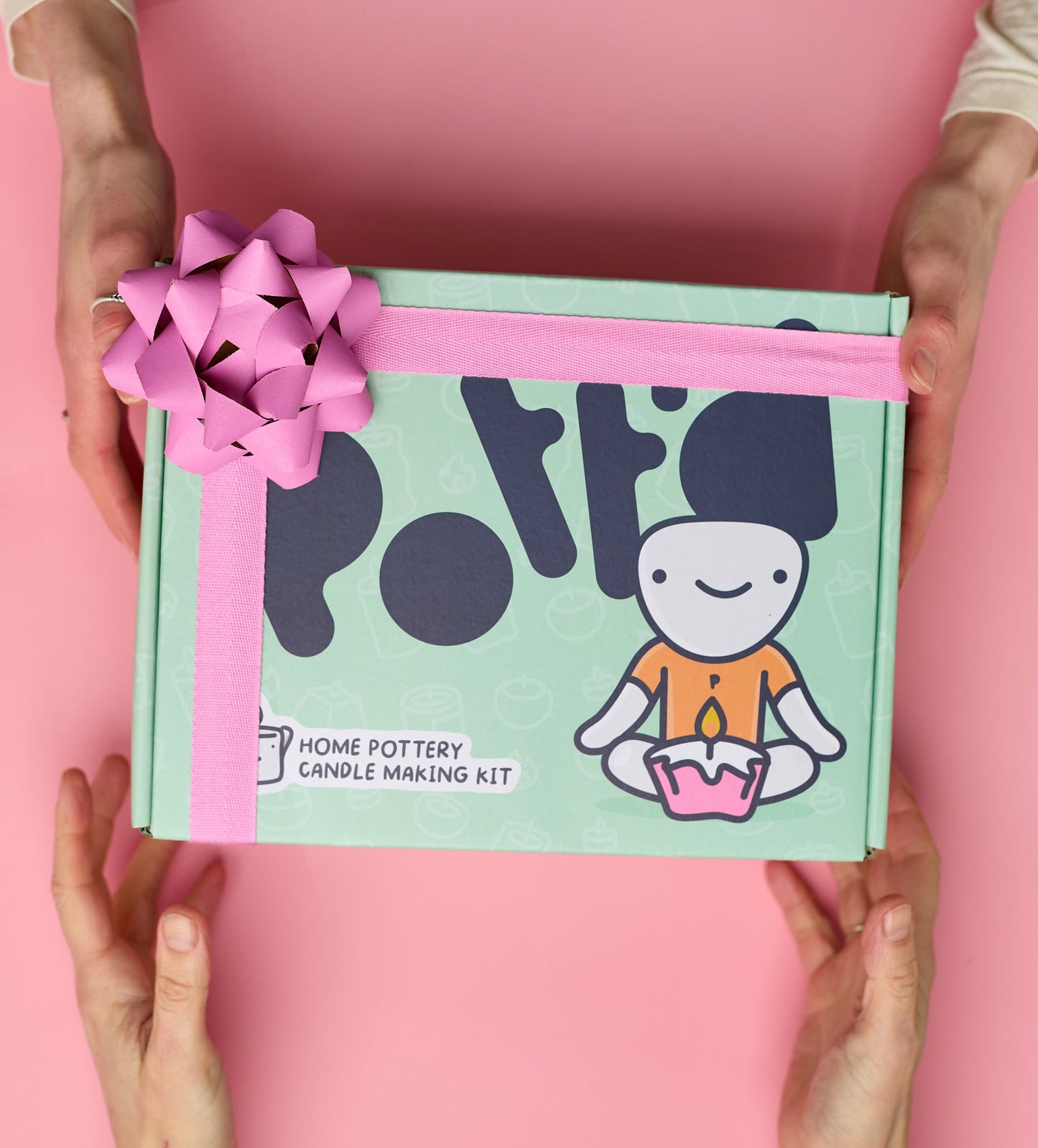 Decorative photo frame being painted with vibrant colors on a pink paper sheet with a creative DIY paint kit.