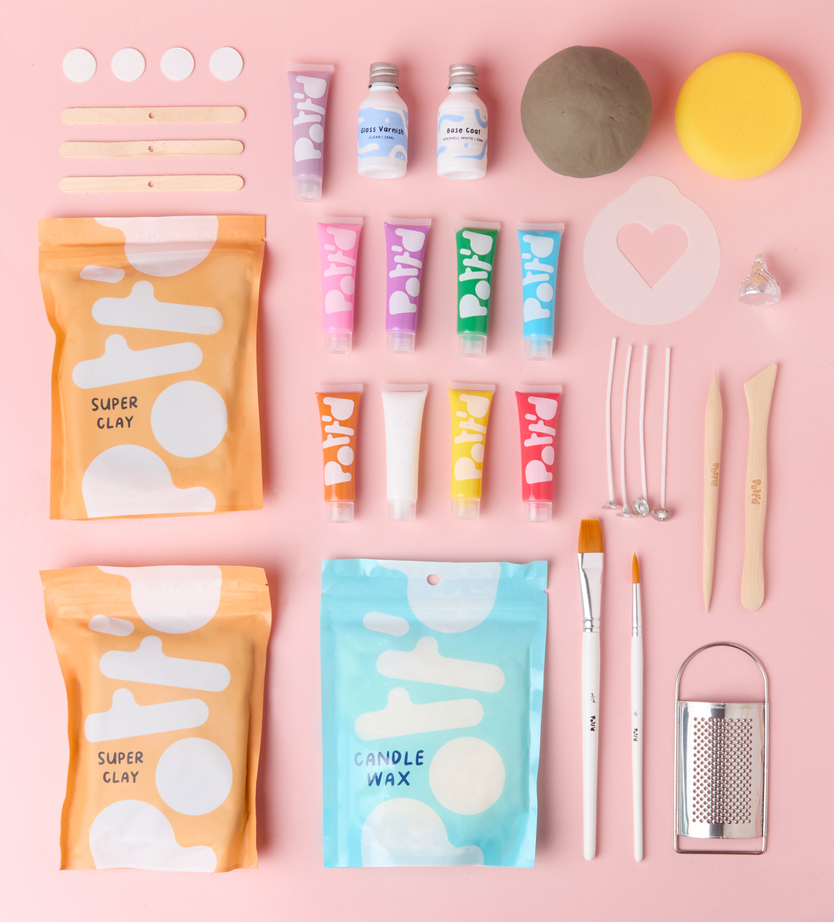 Ceramic loaf-shaped sculpture with date cubes on a pink background, featuring the word "weeks" and numbers.