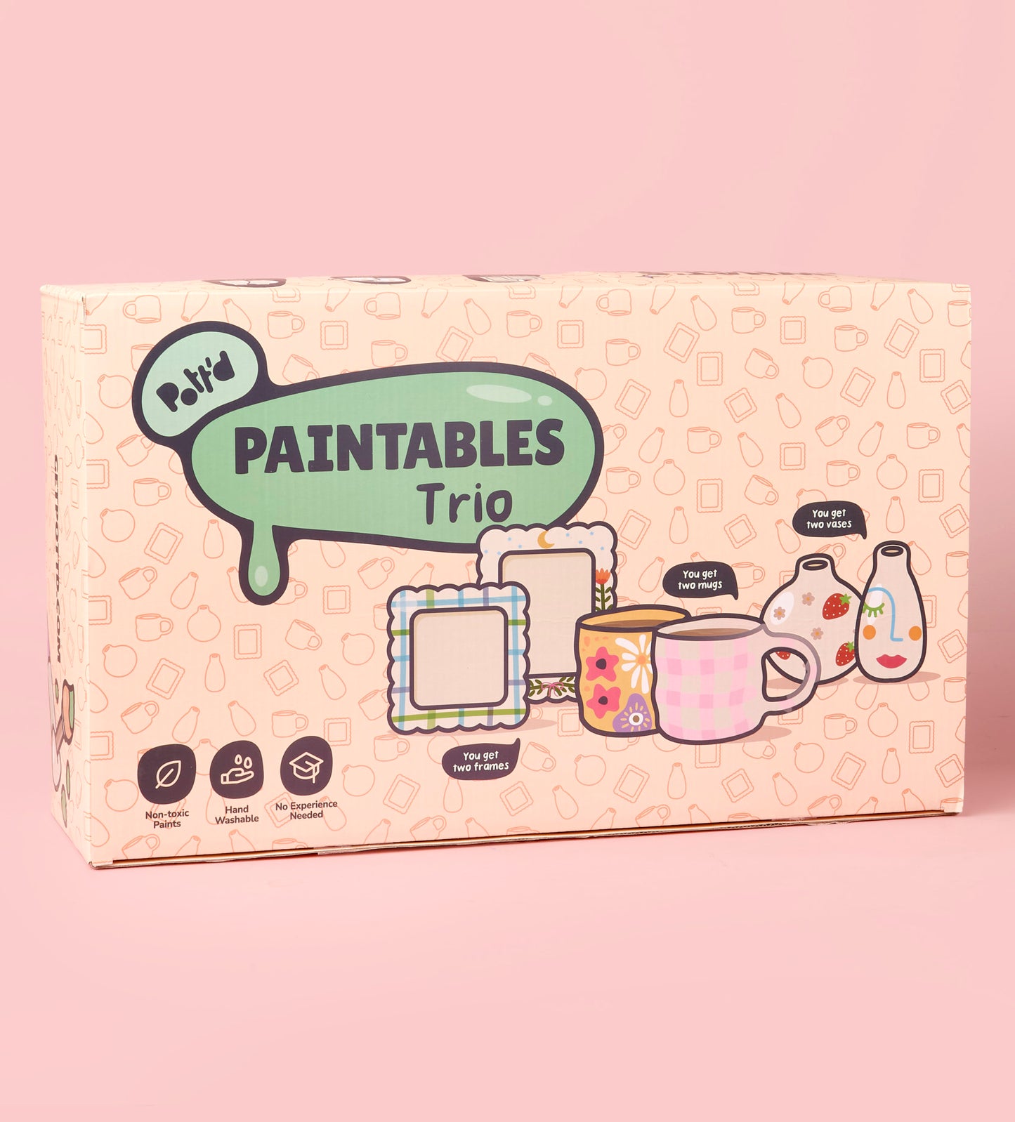 Ceramic mugs with happy designs and clouds on a tabletop alongside a French press coffee maker being poured.