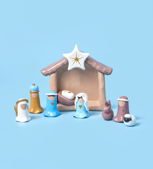 DIY craft kit with premium super clay, pumpkin-shaped mugs, paint, candle wax, and tools on a peach background.