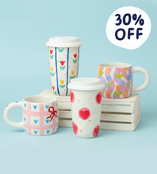 Decorative mugs with colorful patterns including hearts, tulips, and bows, displayed on a crate with a 35% OFF label.