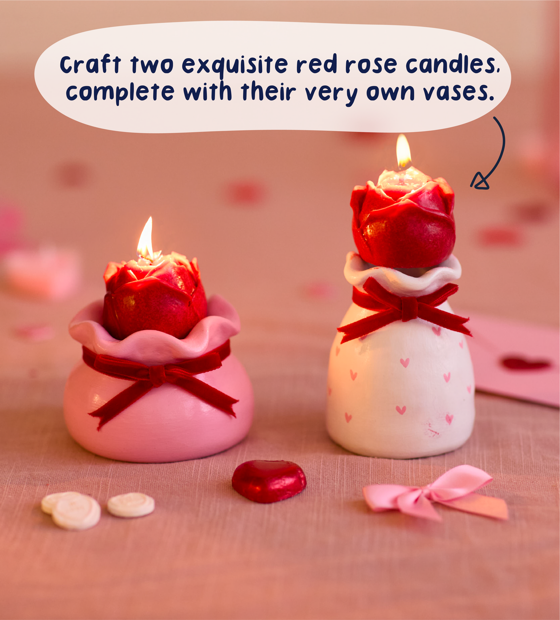 Exquisite red rose candles in pink and white vases with red bows on a soft pink fabric surface.