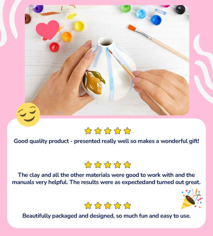 Heart-shaped mug painting kit on a pink background with brushes, vibrant ceramic paints, and an inspiration guide.