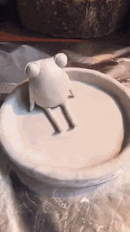 GIF of someone creating a frog/lily pad trinket dish and then painting it 